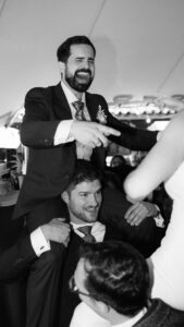 Groom toasting at candlelit wedding reception in Mallorca