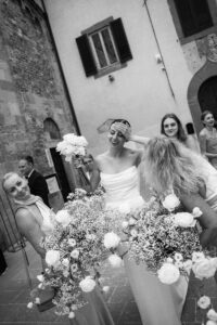 Bride tossing bouquet with bridesmaids classic wedding in Spain