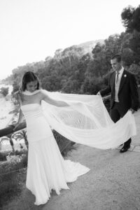 Bride playing with veil at destination wedding in Costa Brava