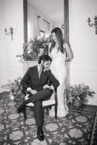 Elegant couple in vintage armchair timeless wedding photo in Madrid