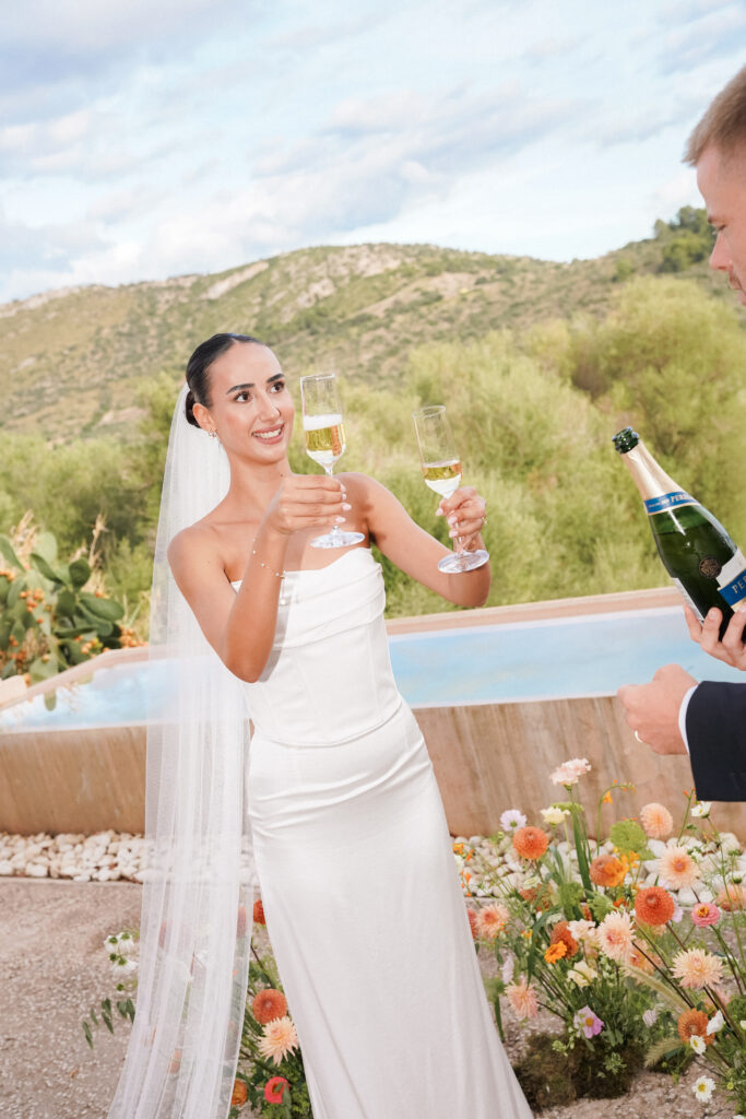 Bride celebrating with champagne at Finca Ses Voltes