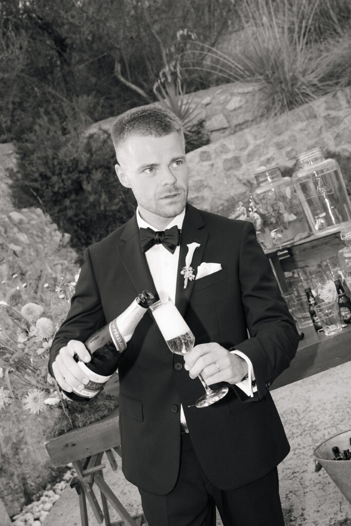 Groom popping champagne at Finca Ses Voltes wedding