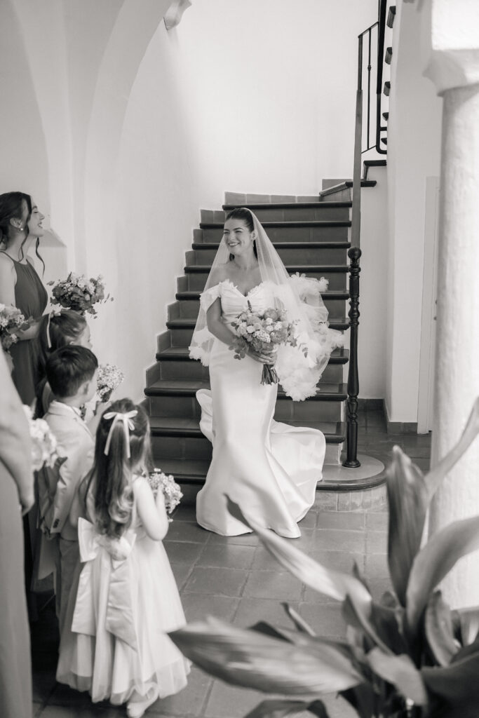 Bride in white dress walking down stairs at Cortijo Bravo